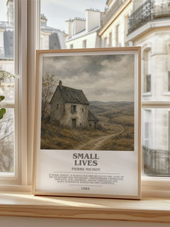 Small Lives Bookish Wall Art by Pierre Michon – framed print by a bright window