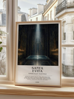 Santa Evita Bookish Wall Art by Tomás Eloy Martínez – framed print by a bright window