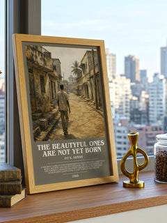 The Beautyful Ones are Not Yet Born Bookish Wall Art by Ayi K. Armah – framed print on a city-view windowsill