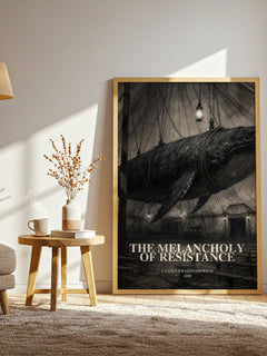 The Melancholy of Resistance watercolour print in frame leaning in hallway – literary fiction wall art