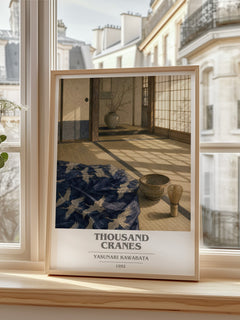 Thousand Cranes book cover print in frame leaning in hallway – literary fiction wall art